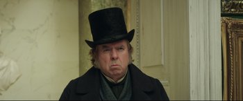 Movie still from “Mr. Turner” (2014), directed by Mike Leigh – A man in a black top hat and a black coat; Close Up shot, Over the shoulder angle
