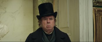 Movie still from “Mr. Turner” (2014), directed by Mike Leigh – A man in a top hat and a black coat; Close Up shot, Over the shoulder angle