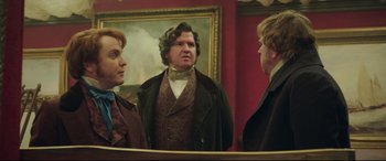 Movie still from “Mr. Turner” (2014), directed by Mike Leigh – A man and two women looking in a mirror; Medium shot, Over the shoulder angle
