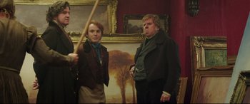 Movie still from “Mr. Turner” (2014), directed by Mike Leigh – Two men standing next to each other in front of a painting; Medium shot, Low angle