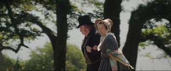 Movie still from “Mr. Turner” (2014), directed by Mike Leigh – A man and a woman walking through the woods; Medium shot, Low angle