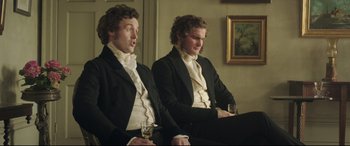 Movie still from “Mr. Turner” (2014), directed by Mike Leigh – A couple of men sitting next to each other holding wine glasses; Medium shot, Over the shoulder angle