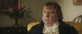 Movie still from “Mr. Turner” (2014), directed by Mike Leigh – An older man in a black jacket and a yellow jacket; Close Up shot, Over the shoulder angle