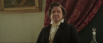 Movie still from “Mr. Turner” (2014), directed by Mike Leigh – A person wearing a suit and tie; Close Up shot, Low angle