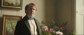 Movie still from “Mr. Turner” (2014), directed by Mike Leigh – A man in a suit standing in front of flowers; Medium shot, Low angle