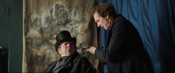Movie still from “Mr. Turner” (2014), directed by Mike Leigh – A man in a top hat and a man in a suit; Medium shot, Over the shoulder angle