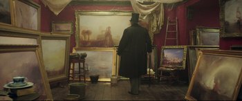Movie still from “Mr. Turner” (2014), directed by Mike Leigh – A man standing in front of several paintings; Wide shot, Low angle