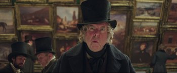 Movie still from “Mr. Turner” (2014), directed by Mike Leigh – A man in a top hat and a black coat; Close Up shot, Low angle