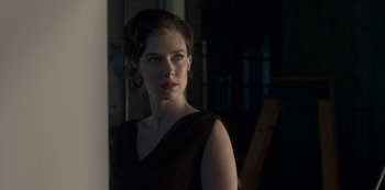 Movie still from “The Crown” (2016), created by Peter Morgan – A beautiful woman in a black dress looking at a mirror; Close Up shot, Low angle