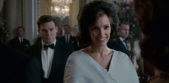 Movie still from “The Crown” (2016), created by Peter Morgan – A woman in a white dress smiling for the camera; Close Up shot, Low angle