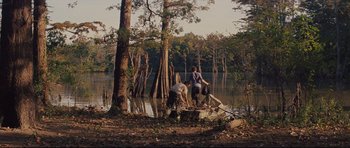 Movie still from “Mud” (2012), directed by Jeff Nichols – Two people in a boat on a river; Extreme Wide shot, High angle