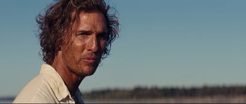 Movie still from “Mud” (2012), directed by Jeff Nichols – A person with long curly hair; Close Up shot, Over the shoulder angle