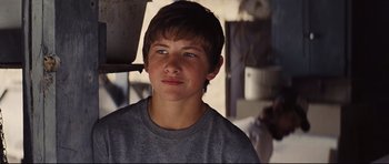 Movie still from “Mud” (2012), directed by Jeff Nichols – A young man with blue eyes is posing for a picture; Close Up shot, Low angle