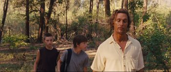 Movie still from “Mud” (2012), directed by Jeff Nichols – A group of young men walking in a forest; Medium shot, Over the shoulder angle