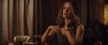 Movie still from “Mud” (2012), directed by Jeff Nichols – A woman sitting at a table with a glass of wine; Close Up shot, Over the shoulder angle