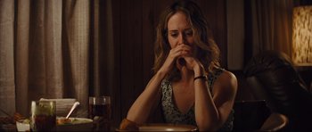 Movie still from “Mud” (2012), directed by Jeff Nichols – A woman sitting in front of a plate of food at a table; Medium shot, Over the shoulder angle