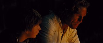 Movie still from “Mud” (2012), directed by Jeff Nichols – Two people are sitting in a dimly - lit room; Close Up shot, Over the shoulder angle