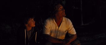 Movie still from “Mud” (2012), directed by Jeff Nichols – A man and a boy are looking up at the sky; Medium shot, Over the shoulder angle