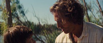 Movie still from “Mud” (2012), directed by Jeff Nichols – A person with long curly hair; Close Up shot, Over the shoulder angle