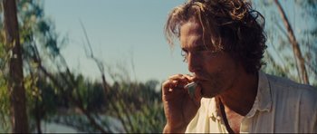 Movie still from “Mud” (2012), directed by Jeff Nichols – A person talking on a cell phone; Close Up shot, Low angle