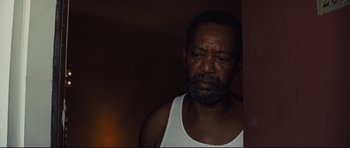 Movie still from “Mud” (2012), directed by Jeff Nichols – An older man with a beard is looking sad; Close Up shot, Low angle