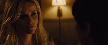Movie still from “Mud” (2012), directed by Jeff Nichols – A woman is looking at the camera while a man sits in the background; Close Up shot, Over the shoulder angle