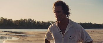 Movie still from “Mud” (2012), directed by Jeff Nichols – A person standing on a beach; Close Up shot, Over the shoulder angle