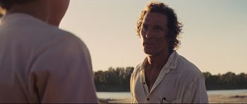 Movie still from “Mud” (2012), directed by Jeff Nichols – A person standing near a body of water; Close Up shot, Over the shoulder angle