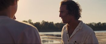 Movie still from “Mud” (2012), directed by Jeff Nichols – A person near a body of water; Close Up shot, Over the shoulder angle