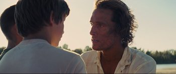 Movie still from “Mud” (2012), directed by Jeff Nichols – A man and a boy are talking in a field; Close Up shot, Over the shoulder angle