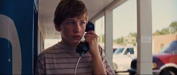 Movie still from “Mud” (2012), directed by Jeff Nichols – A boy holding a phone up to his ear; Close Up shot, Low angle