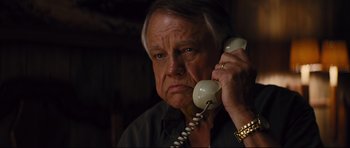 Movie still from “Mud” (2012), directed by Jeff Nichols – An older man holding a phone to his ear; Close Up shot, Low angle