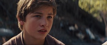 Movie still from “Mud” (2012), directed by Jeff Nichols – A young boy's face with trees in the background; Close Up shot, High angle