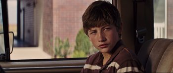 Movie still from “Mud” (2012), directed by Jeff Nichols – A young boy sitting in front of a window; Close Up shot, Over the shoulder angle