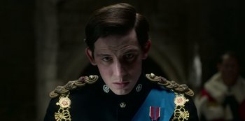 Movie still from “The Crown” (2016), created by Peter Morgan – A person wearing a uniform; Close Up shot, Low angle