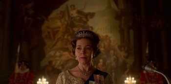 Movie still from “The Crown” (2016), created by Peter Morgan – A person wearing a tiara; Medium shot, Low angle