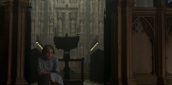 Movie still from “The Crown” (2016), created by Peter Morgan – A young girl sitting in front of an altar in a church; Wide shot, High angle