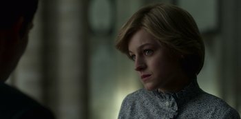 Movie still from “The Crown” (2016), created by Peter Morgan – A woman with short blonde hair wearing a blue shirt; Close Up shot, Low angle