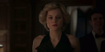 Movie still from “The Crown” (2016), created by Peter Morgan – A woman with blonde hair wearing a black dress; Close Up shot, Low angle