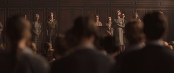 Movie still from “Never Let Me Go” (2010), directed by Mark Romanek – A group of people standing in a courtroom; Wide shot, Low angle