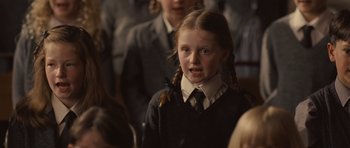 Movie still from “Never Let Me Go” (2010), directed by Mark Romanek – A young girl in a school uniform with pigtails; Close Up shot, Over the shoulder angle