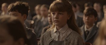 Movie still from “Never Let Me Go” (2010), directed by Mark Romanek – A young girl in a crowd of people; Close Up shot, Over the shoulder angle