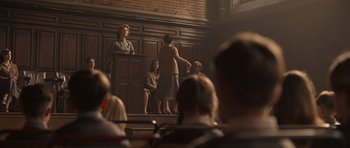 Movie still from “Never Let Me Go” (2010), directed by Mark Romanek – A group of people standing in front of an audience; Wide shot, Low angle