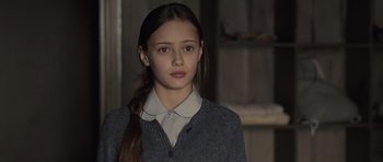 Movie still from “Never Let Me Go” (2010), directed by Mark Romanek – A young girl in a grey sweater and a white shirt; Close Up shot, Over the shoulder angle