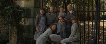 Movie still from “Never Let Me Go” (2010), directed by Mark Romanek – A group of young girls posing for a picture; Medium shot, High angle