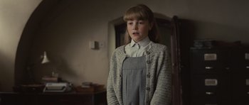 Movie still from “Never Let Me Go” (2010), directed by Mark Romanek – A young girl standing in front of a mirror; Medium shot, Low angle