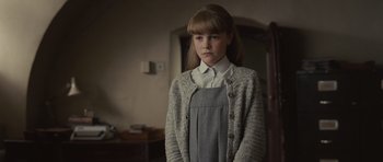 Movie still from “Never Let Me Go” (2010), directed by Mark Romanek – A young girl standing in front of a mirror; Medium shot, Over the shoulder angle