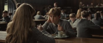 Movie still from “Never Let Me Go” (2010), directed by Mark Romanek – A boy sitting at a table in front of a plate of food; Medium shot, Over the shoulder angle