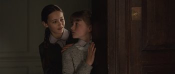 Movie still from “Never Let Me Go” (2010), directed by Mark Romanek – Two young people are standing next to each other; Close Up shot, Over the shoulder angle