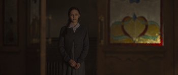 Movie still from “Never Let Me Go” (2010), directed by Mark Romanek – A young girl standing in a dark room; Medium shot, Over the shoulder angle
